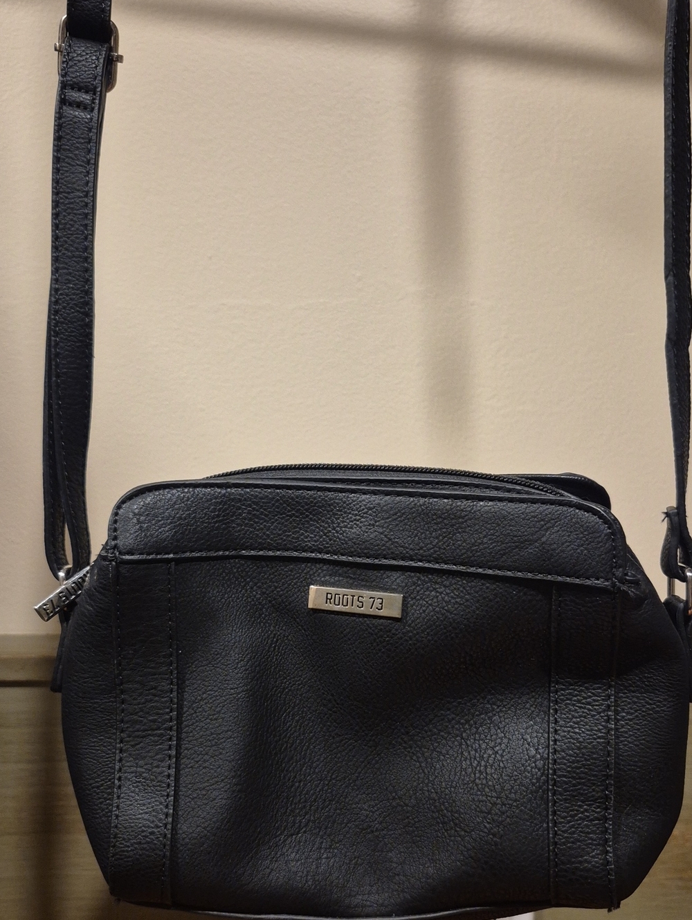 Roots Black Pebbled Leather Crossbody Purse with Metal Logo